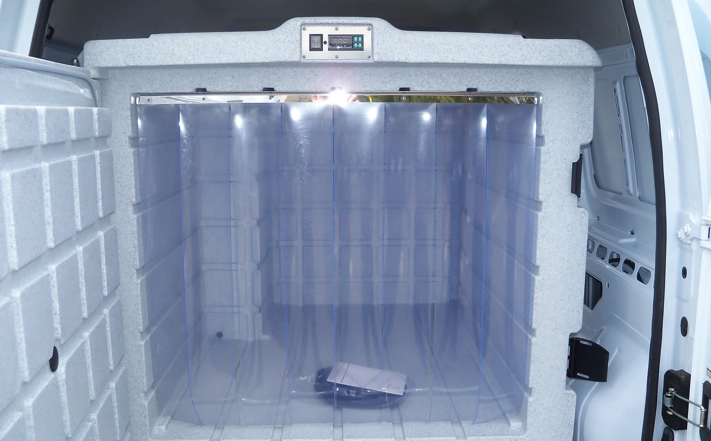 An open Coldtainer F0330 AuO with a clear strip curtain inside the door