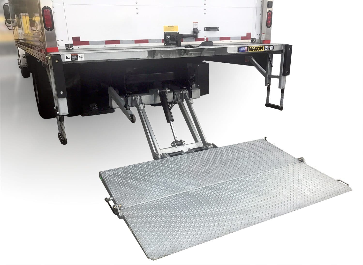 A Maxon TE Tuk-A-Way liftgate with its platform lowered at the rear of a box truck