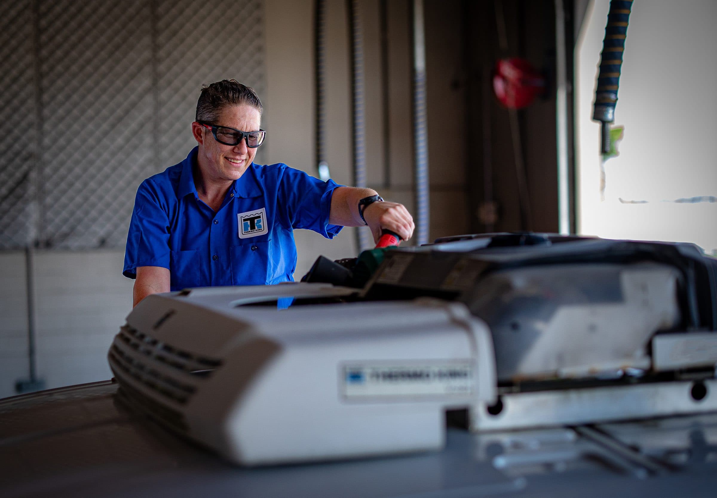 A technician working on a Thermo King van unit
