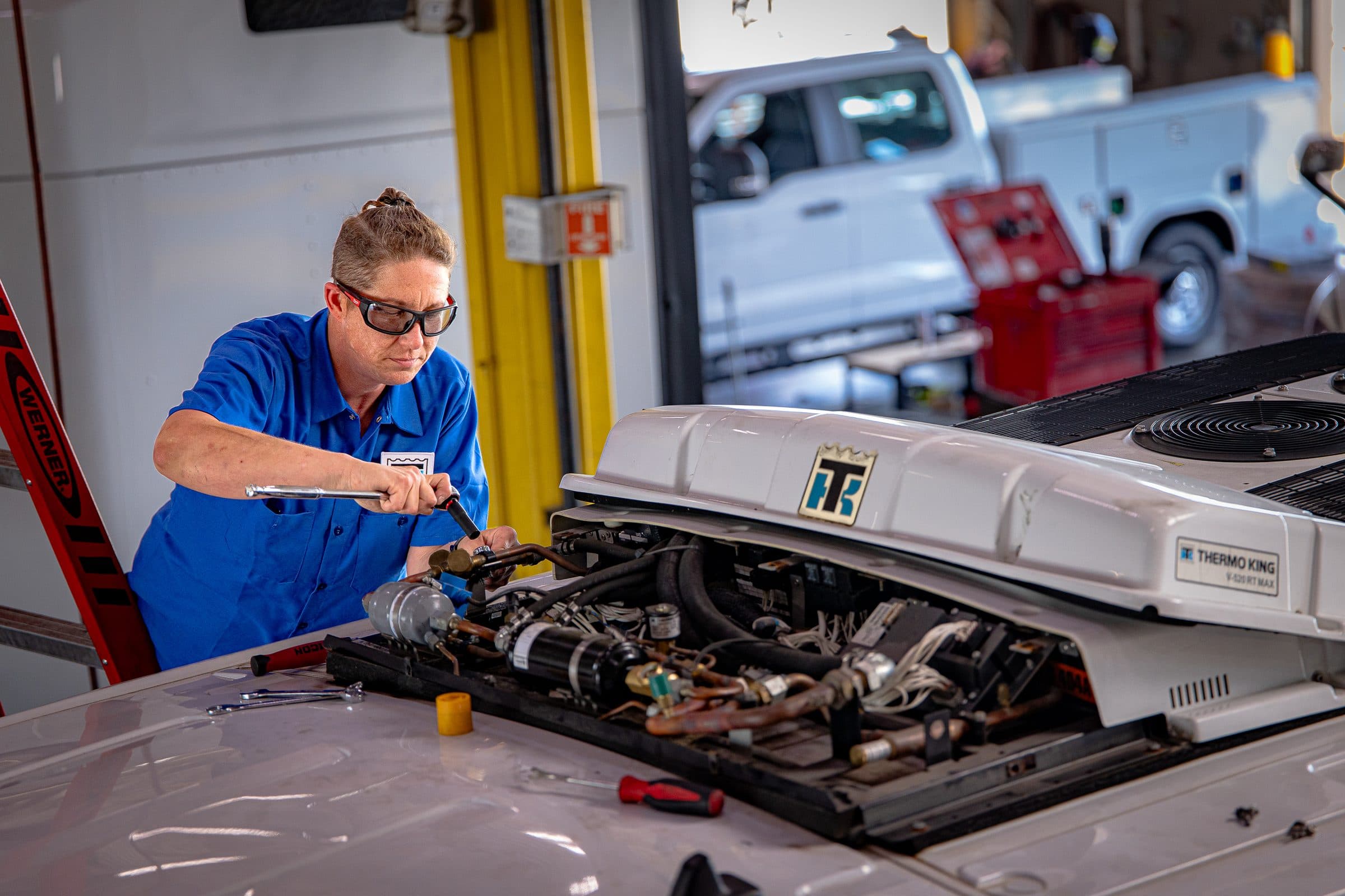A technician working on a Thermo King V-520 RT MAX unit