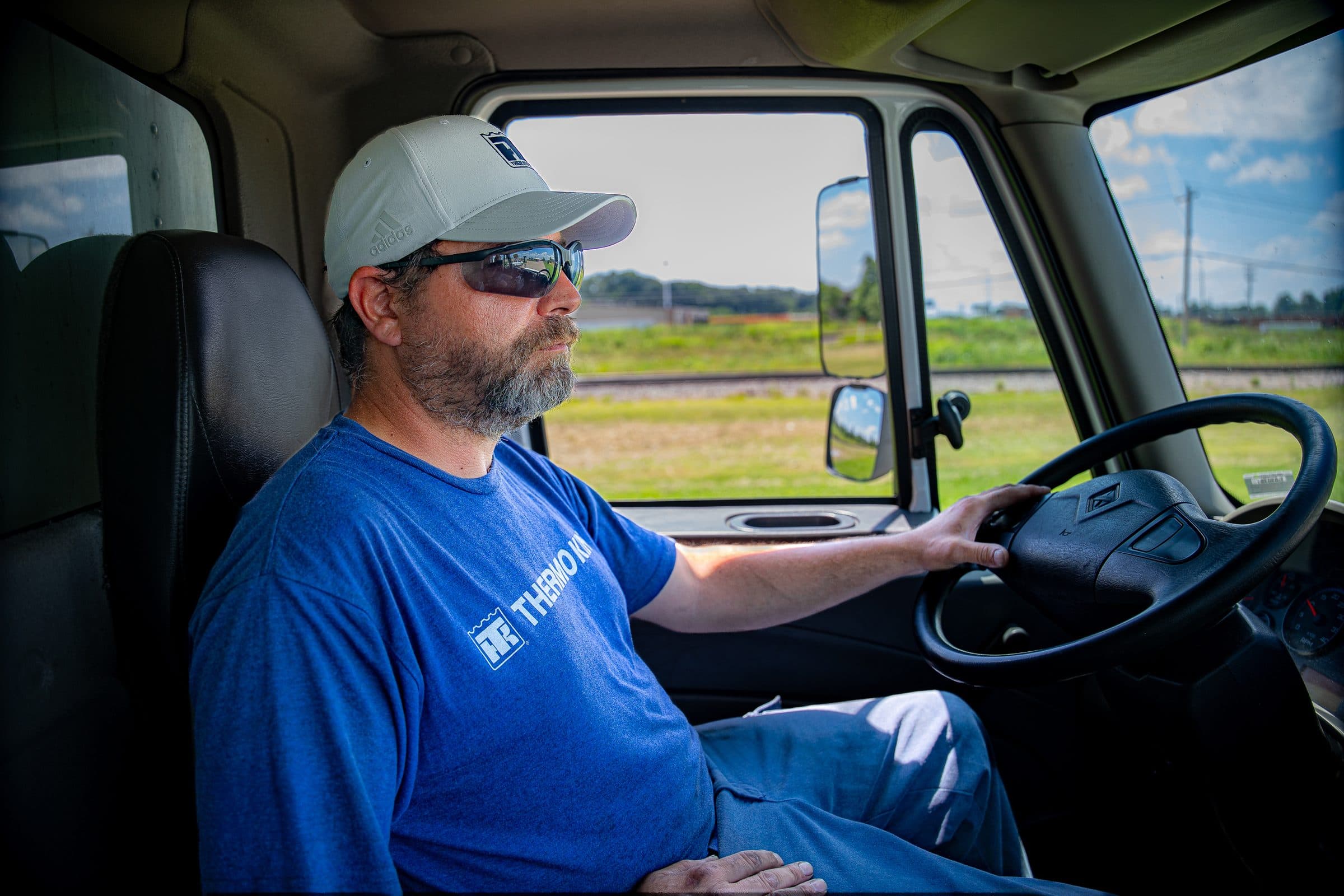 A technician at the wheel of a service truck