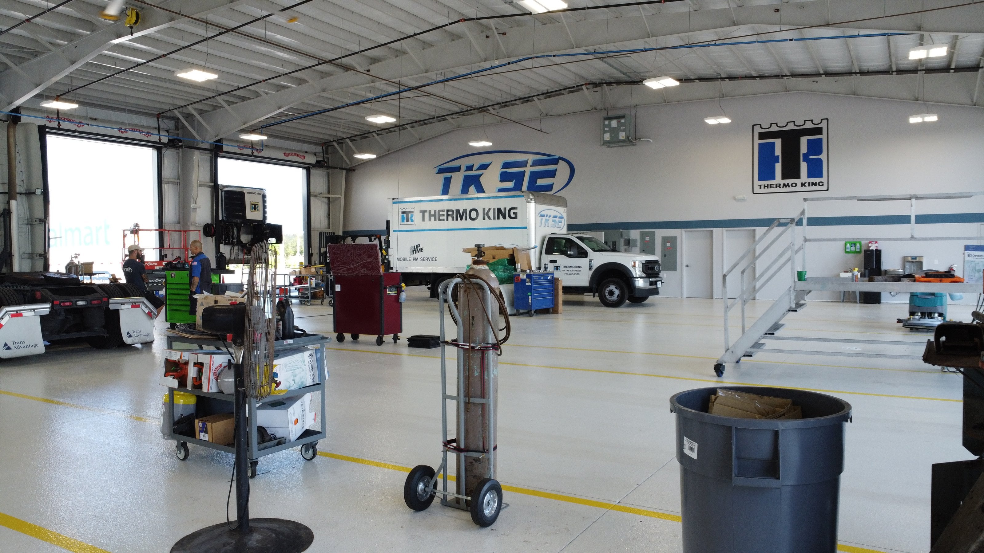 The bay floor at TKSE's Fort Pierce shop: a TKSE service truck, work stands and carts under the TKSE and Thermo King logos